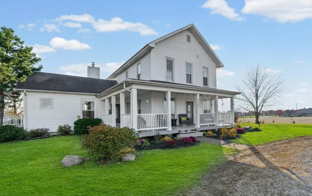 a front view of house with yard and green space
