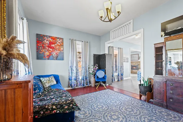 a bedroom with furniture and a flat screen tv