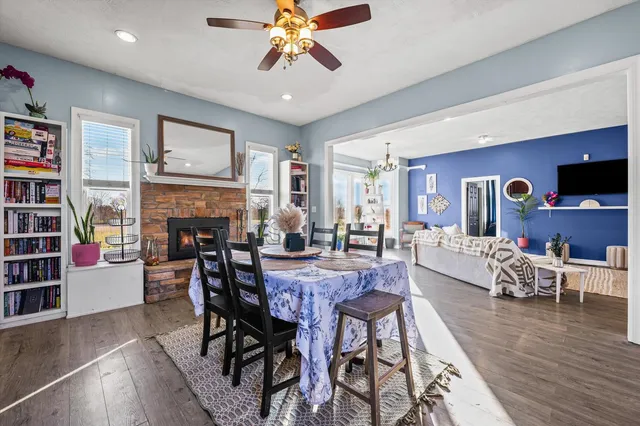 a view of a dining room with furniture a rug and wooden floor
