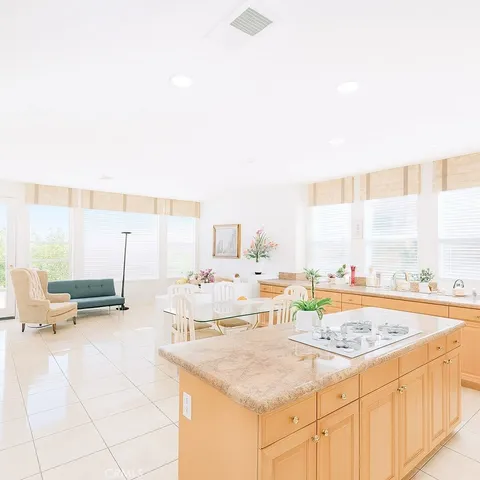a kitchen with stainless steel appliances kitchen island granite countertop a sink and cabinets