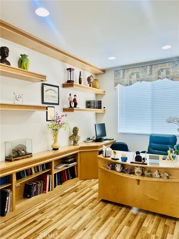 a room with stainless steel appliances kitchen island granite countertop a sink a stove and wooden cabinets