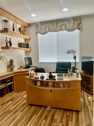 a room with wooden floor and furniture