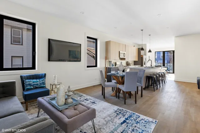 a living room with furniture a rug and a flat screen tv