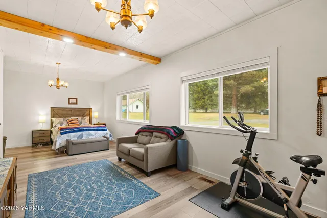 a living room with furniture gym equipment and a large window