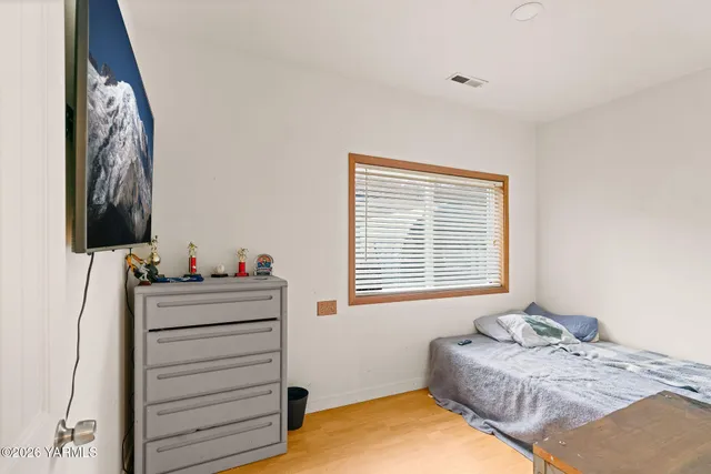 a bedroom with a bed and a dresser