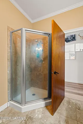 a bathroom with a glass shower door