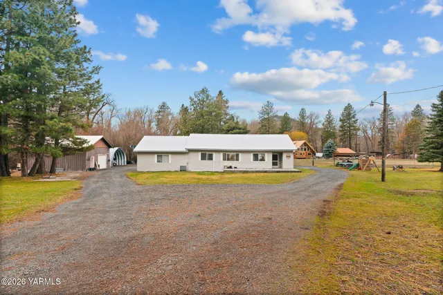 a view of a swimming pool with an outdoor seating and a yard