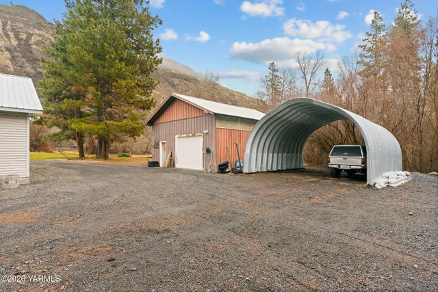 a view of a house with a yard and garage