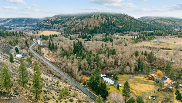an aerial view of a house with a yard
