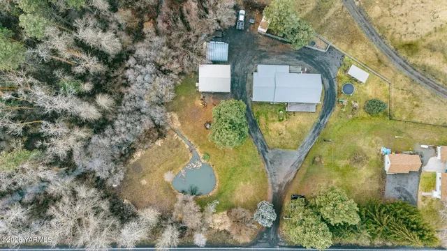 an aerial view of a house with a yard