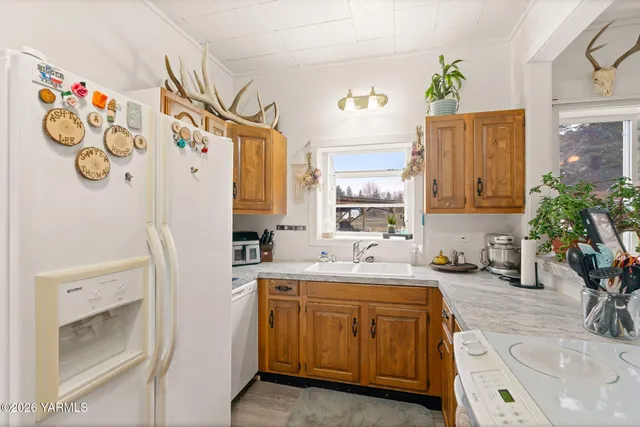 a bathroom with a sink a faucet a mirror and a shower