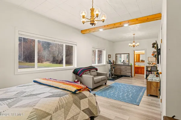 a living room with furniture gym equipment and a large window