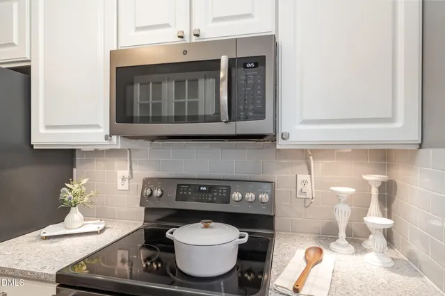 a kitchen with a stove and cabinets