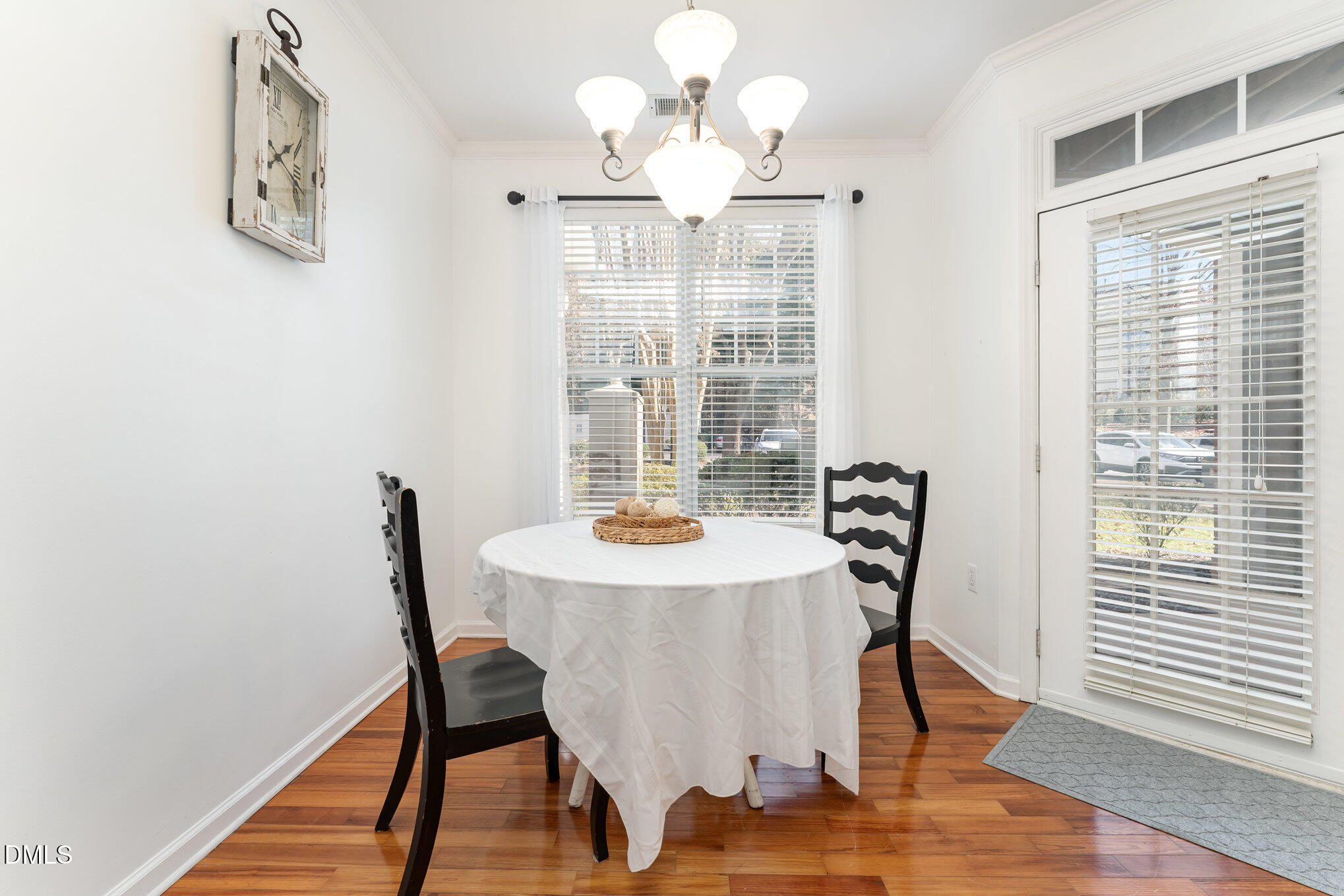 8231 Allyns Landing Way, Unit 101 Raleigh, NC 27615 - Photo 12 of 25 a view of a dining room with furniture window and wooden floor