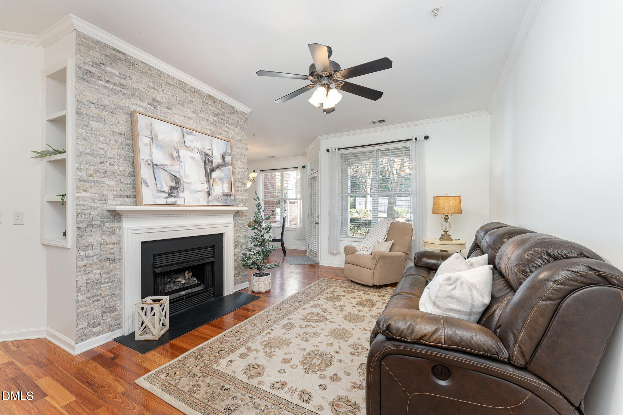 8231 Allyns Landing Way, Unit 101 Raleigh, NC 27615 - Photo 14 of 25 a living room with furniture a window and a fireplace
