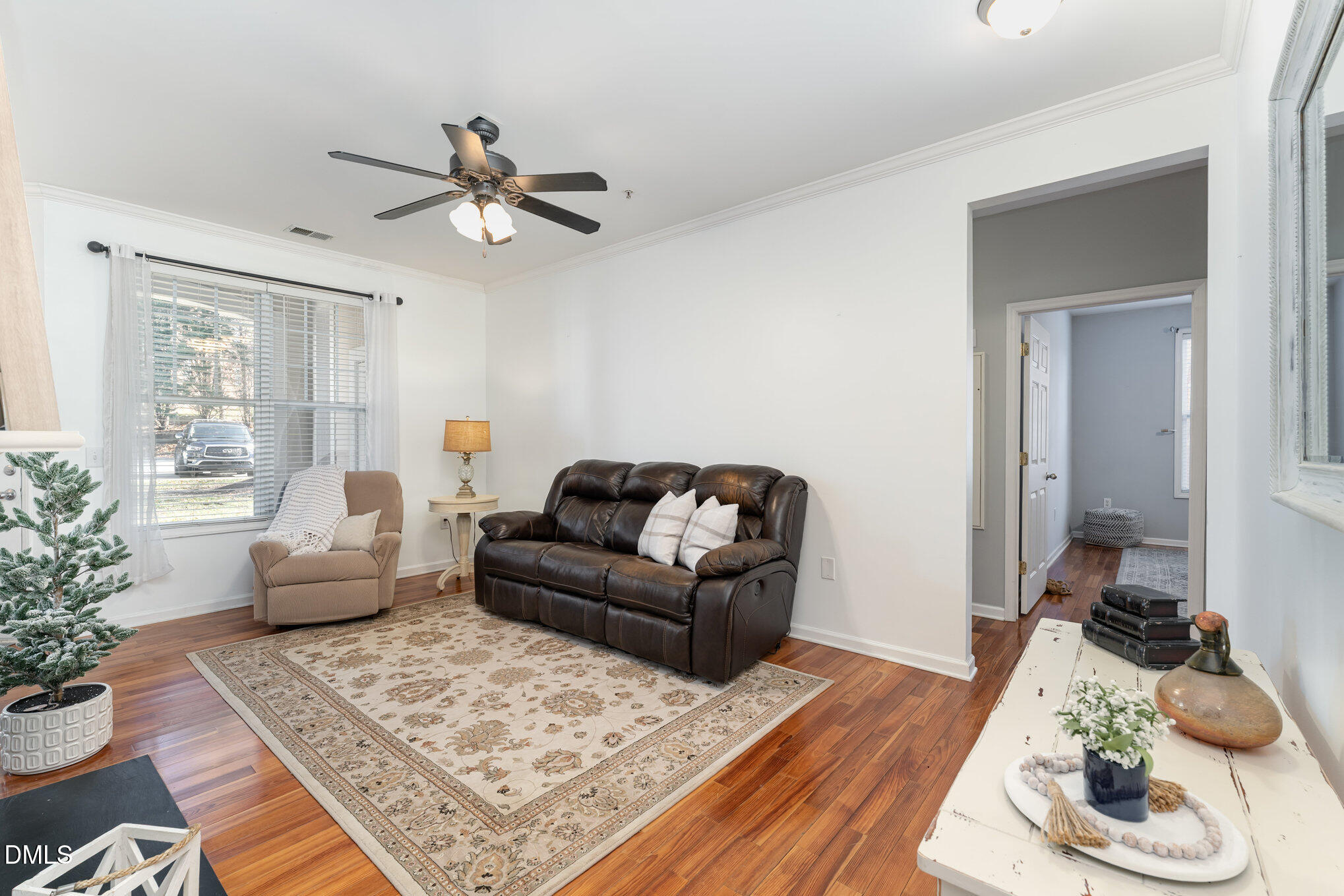 8231 Allyns Landing Way, Unit 101 Raleigh, NC 27615 - Photo 15 of 25 a living room with furniture and a wooden floor
