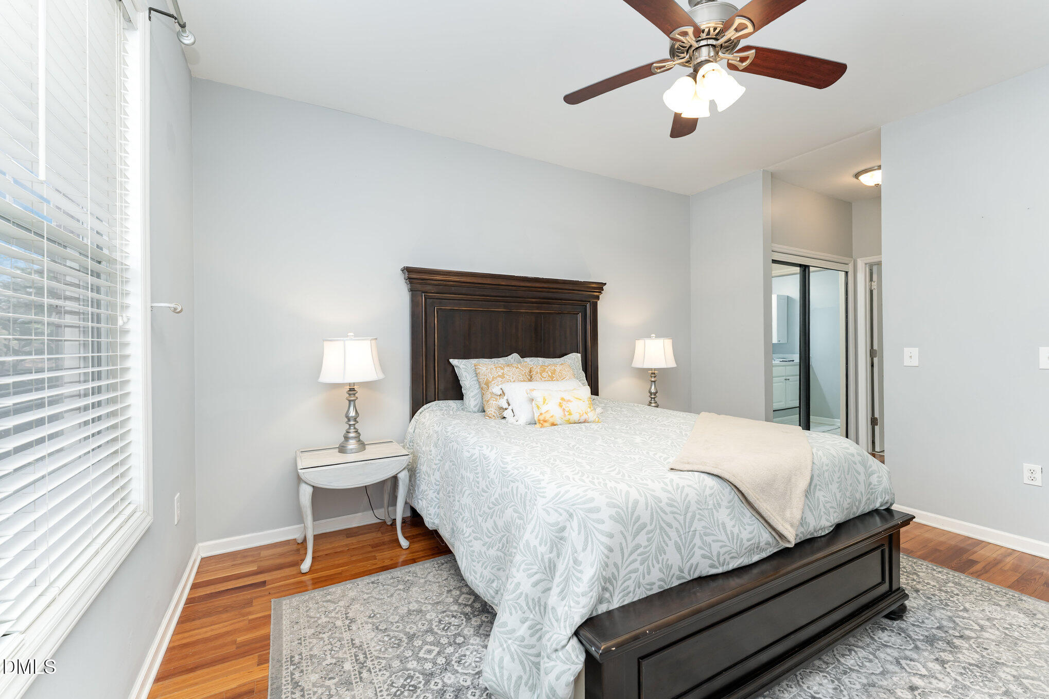 8231 Allyns Landing Way, Unit 101 Raleigh, NC 27615 - Photo 18 of 25 a bedroom with a bed and a chandelier