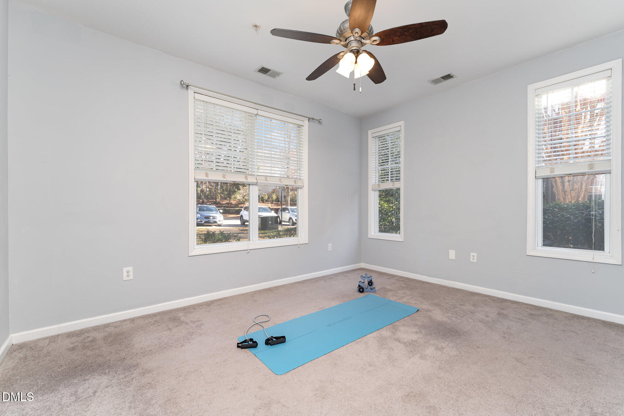 8231 Allyns Landing Way, Unit 101 Raleigh, NC 27615 - Photo 20 of 25 an empty room with windows and fan