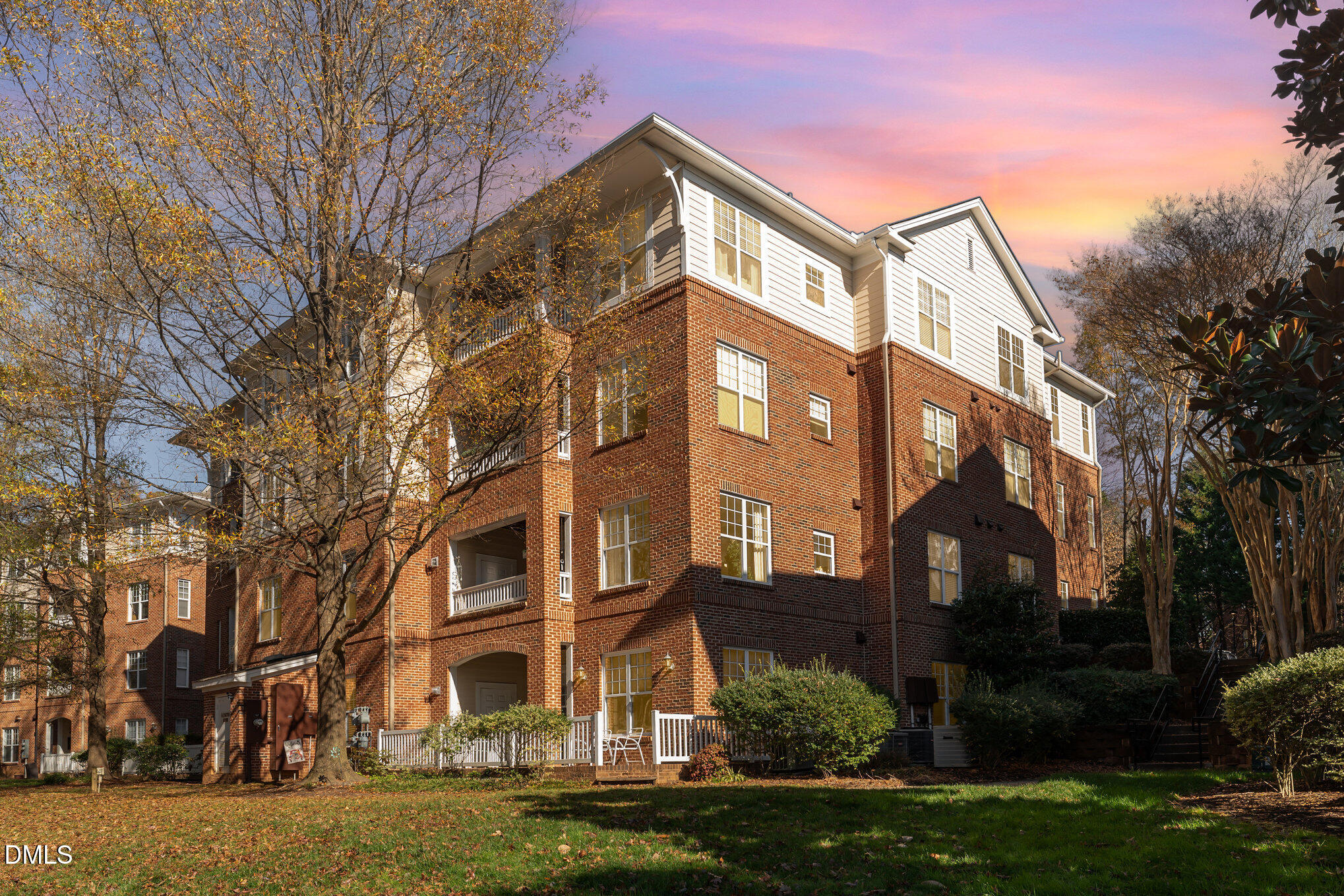 8231 Allyns Landing Way, Unit 101 Raleigh, NC 27615 - Photo 4 of 25 a front view of a residential apartment building with yard and green space