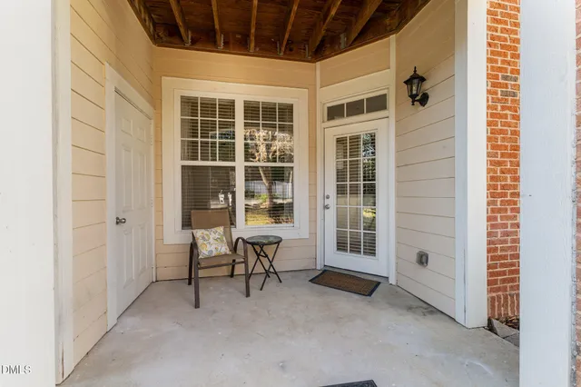 a view of a house with a large window and chair