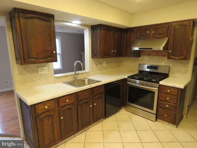 a kitchen with stainless steel appliances granite countertop a sink and cabinets