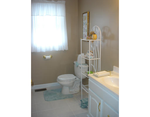 96 Mashapaug Road Sturbridge, MA 01566 - Photo 12 of 30 a bathroom with a toilet a sink and mirror