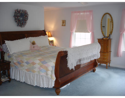 96 Mashapaug Road Sturbridge, MA 01566 - Photo 13 of 30 a bed sitting in a bedroom next to a window