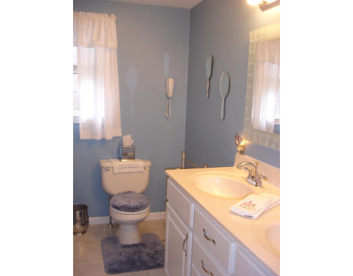 96 Mashapaug Road Sturbridge, MA 01566 - Photo 16 of 30 a bathroom with a sink toilet mirror and vanity