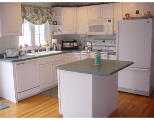 96 Mashapaug Road Sturbridge, MA 01566 - Photo 6 of 30 a kitchen with stainless steel appliances granite countertop a sink stove and refrigerator