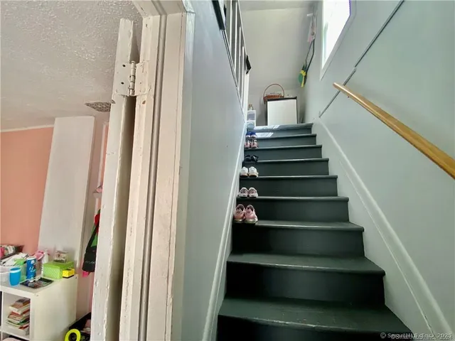a view of a hallway with workspace and living room