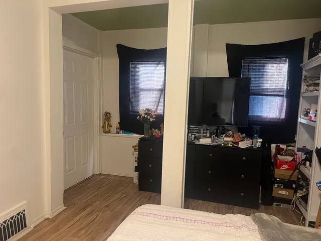 a bedroom with a bed and a dresser