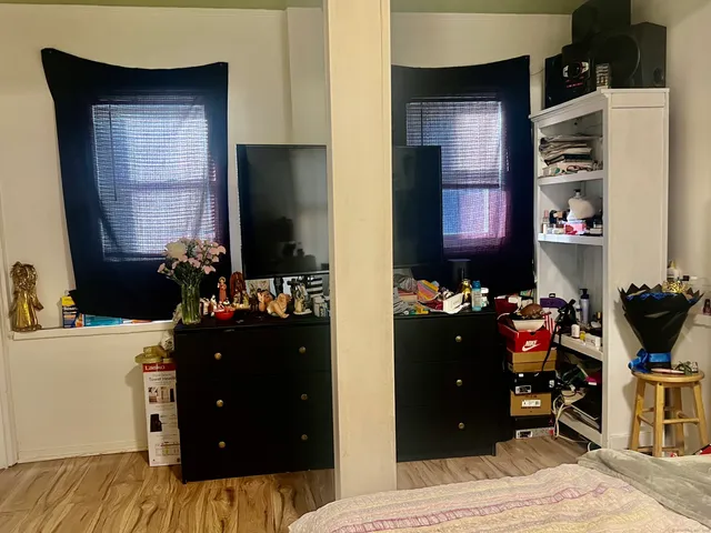 a bedroom with a bed and wooden floor