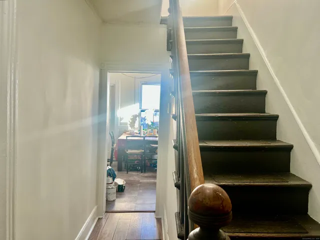 a kitchen with stainless steel appliances granite countertop a stove top oven a sink dishwasher and cabinets with wooden floor