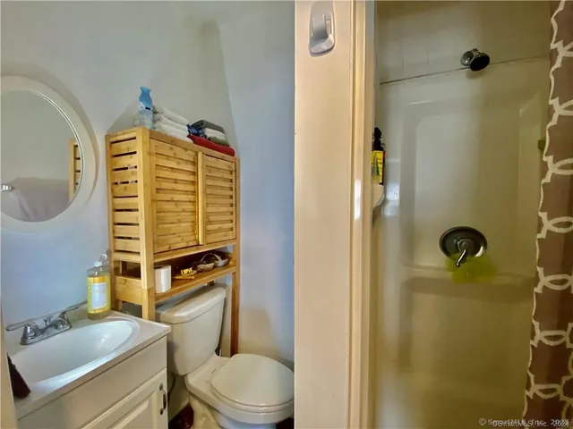 a view of a hallway with wooden floor and stairs