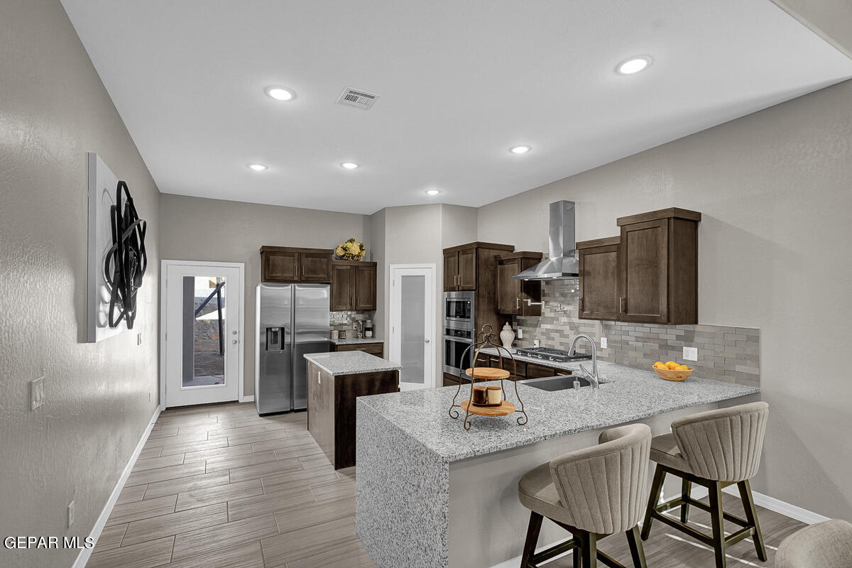 15113 Conviction El Paso, TX 79938 - Photo 13 of 42 a kitchen with refrigerator and chairs