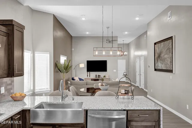 a kitchen with a stove a refrigerator and a sink