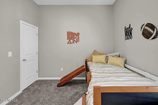 a bed sitting in a bedroom next to a window