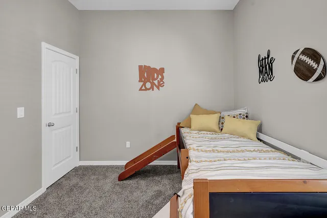 a bed sitting in a bedroom next to a window