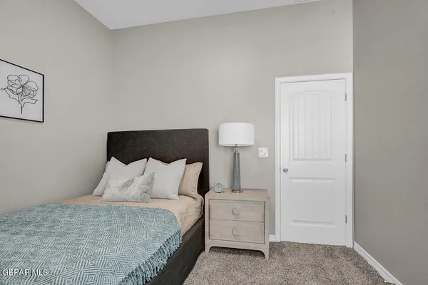 a bedroom with a bed and a lamp