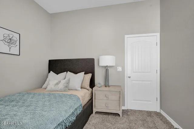 a bedroom with a bed and a lamp