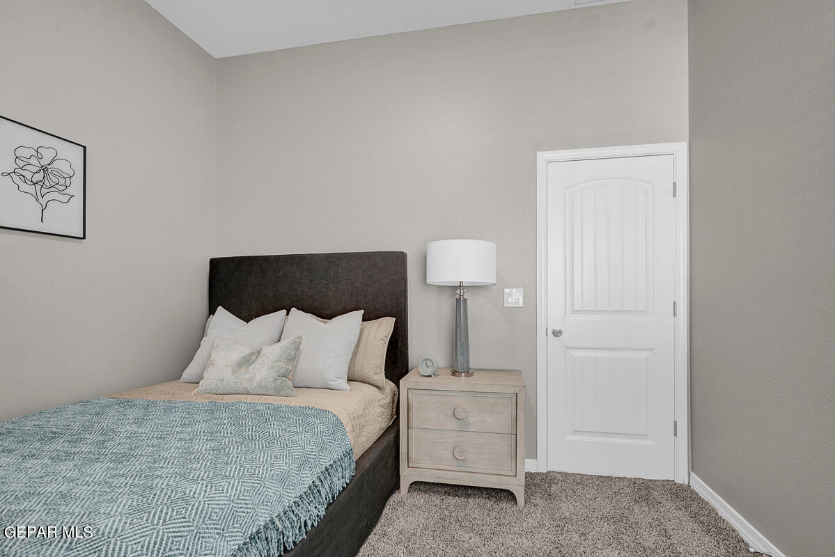 15113 Conviction El Paso, TX 79938 - Photo 23 of 42 a bedroom with a bed and a lamp