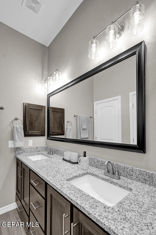 15113 Conviction El Paso, TX 79938 - Photo 27 of 42 a bathroom with a granite countertop sink double and mirror