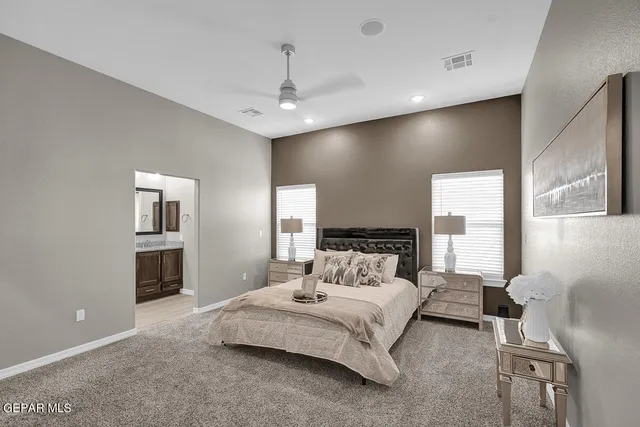 a bedroom with a large bed and a chandelier