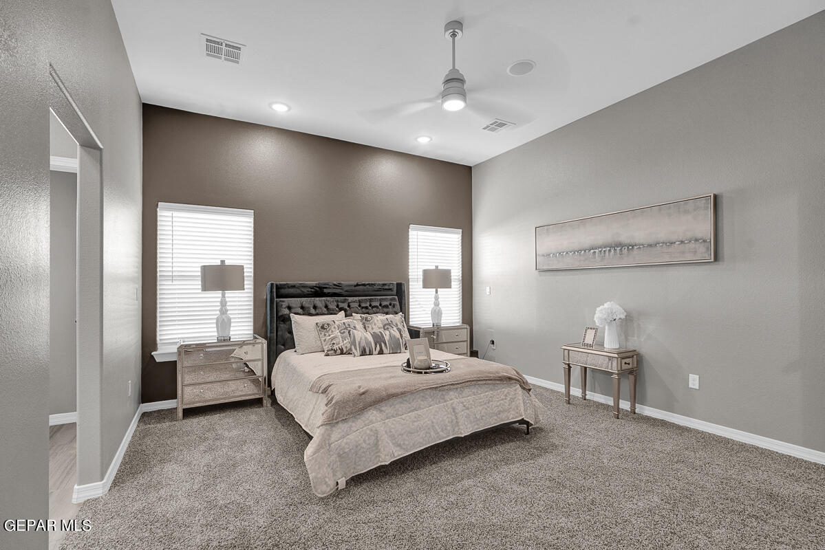 15113 Conviction El Paso, TX 79938 - Photo 30 of 42 a bedroom with a large bed and a chandelier