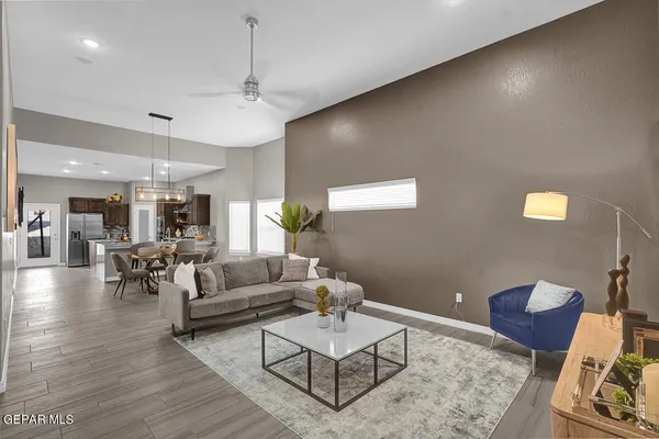 a living room with furniture and a chandelier
