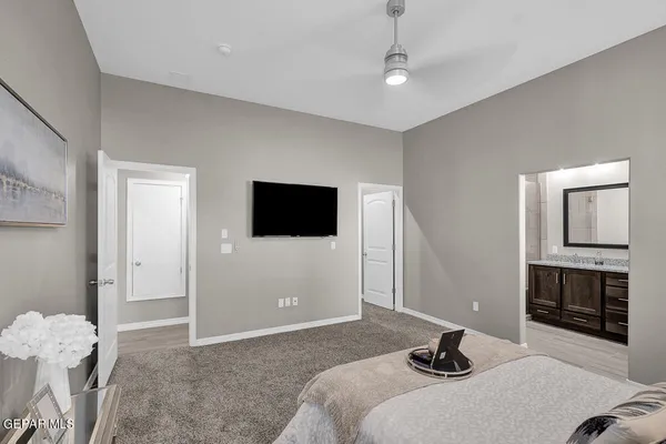 a bedroom with a bed and a flat screen tv