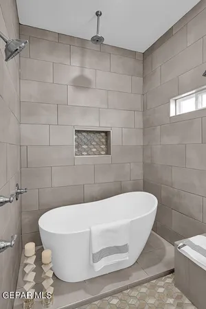 a white bath tub sitting in a bathroom