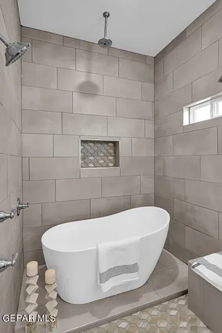 a white bath tub sitting in a bathroom