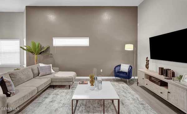 a living room with furniture and a flat screen tv