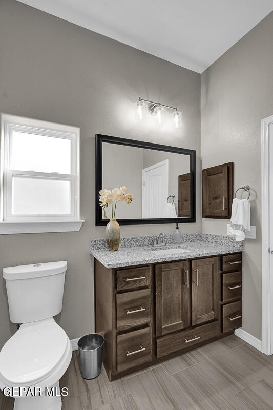15113 Conviction El Paso, TX 79938 - Photo 41 of 42 a bathroom with a toilet a sink and a mirror